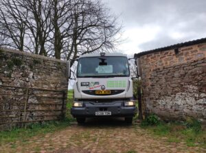 Throw and tow van driving through gate