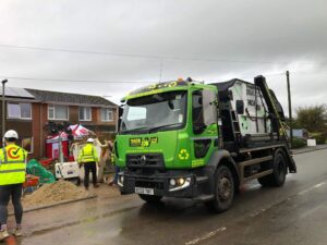 Throw and Tow Skip Lorry in front of customer's home